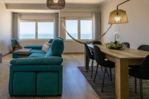 a living room with a blue couch and a table at Blue House in Santa Cruz with Sea View in Santa Cruz