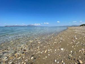 a rocky beach with rocks in the water at Bitter Orange House in Nerántza