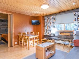 a living room with a table and a dining room at Holiday Home Lomarati 3 by Interhome in Saariselka