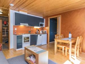 a kitchen with a table and a dining room at Holiday Home Lomarati 3 by Interhome in Saariselka