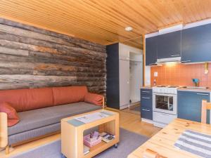 a living room with a couch and a kitchen at Holiday Home Lomarati 3 by Interhome in Saariselka