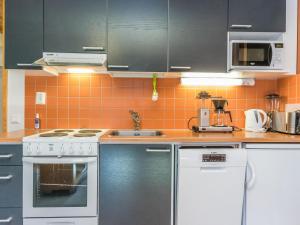 a kitchen with a stove and a sink at Holiday Home Lomarati 3 by Interhome in Saariselka +7 photos