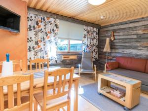 a living room with a couch and a table at Holiday Home Lomarati 3 by Interhome in Saariselka