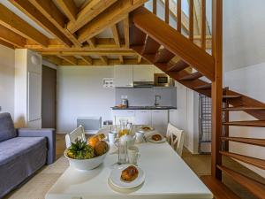 a kitchen and living room with a table with food on it at Apartment Le Château de Kergonano-20 by Interhome in Baden