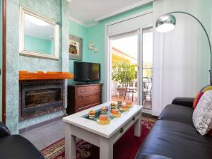 a living room with a couch and a tv and a table at Holiday Home Villa Angeles by Interhome in L'Ametlla de Mar