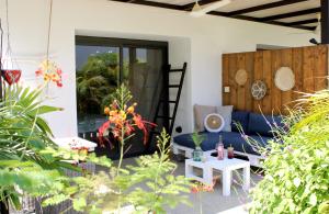 a patio with a blue couch and a table at Casa Mantana Bonaire in Kralendijk