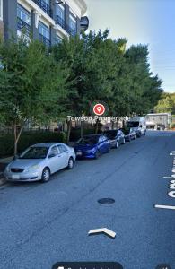 een rij auto's geparkeerd aan de kant van een straat bij Towson Elite Apartment in Towson