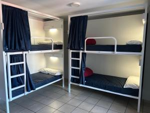 a room with three bunk beds in it at Albergue San Anton in Melide +59 photos