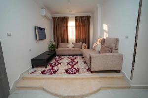 a living room with a couch and a chair at Hostel in Quseir