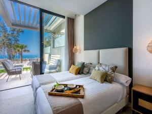 a bedroom with a bed with a tray of food on it at Holiday Home Ocean Front-Cordial Santa Águeda by Interhome in Arguineguín