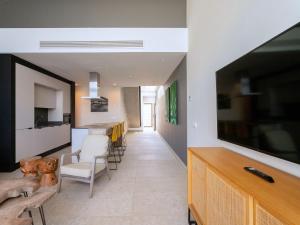 a living room with a large flat screen tv at Holiday Home Ocean Front-Cordial Santa Águeda by Interhome in Arguineguín