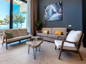 a living room with two couches and a table at Holiday Home Ocean Front-Cordial Santa Águeda by Interhome in Arguineguín