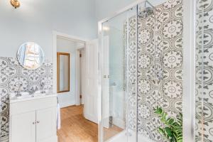 a bathroom with a shower and a mirror at Stunning Historic Suffolk Mansion in Beccles