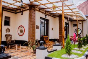 a house with a patio with chairs and plants at Simaza Villa in Kigali