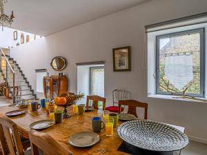 a dining room with a wooden table and chairs at Holiday Home Maison Maison Ty Mad by Interhome in Belz