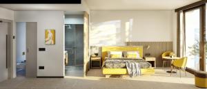 1 dormitorio con cama amarilla y silla amarilla en Garda Suite Hotel - TonelliHotels, en Riva del Garda