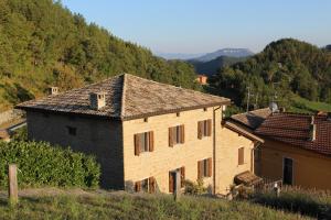 a building in a field with a mountain at Ca' Nobili - Charming Country House 