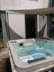 a jacuzzi tub in the backyard of a house at Studio 42 in Petit-Bourg