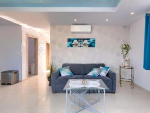 a living room with a blue couch and a table at Holiday Home Villa Fenix by Interhome in Žminj +38 photos