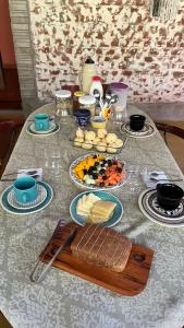 a table with plates of food on top of it at Casa Cacau Boutique B&B - Sítio Salamandra, Vale do Matutu in Aiuruoca +31 photos