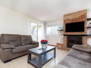 a living room with a couch and a fireplace at Holiday Home Escorpio-1 by Interhome in Tossa de Mar