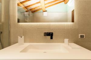 a bathroom with a white sink and a mirror at B&B Al Vecchio Forno in Montepulciano