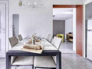 a dining room with a table and white chairs at Holiday Home bonnegrace by Interhome in Six-Fours-les-Plages