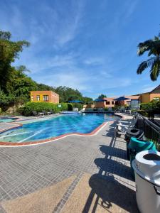a swimming pool with blue water in a resort at Hotel Campestre la Vega Inn in La Vega