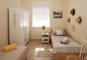 two beds in a small room with a window at Silvermoon Apartment in Kostrena