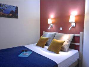 una habitación de hotel con una cama con un libro encima en Apartment Village Cap Estérel - Le Village-79 by Interhome, en Agay - Saint Raphael