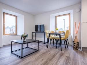 a living room with a table and chairs in a room at Apartment Harbour Nights 7C by Interhome in Lossiemouth