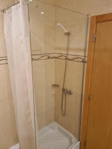 a shower in a bathroom with a shower curtain at APARTAMENTOS CABRITA in Olhos de Água +29 photos