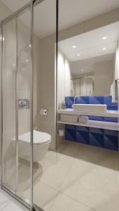 a bathroom with a glass shower and a toilet at Holiday Inn Express Porto - Boavista, an IHG Hotel in Porto