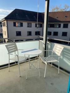 two chairs and a table on a balcony at Sunny studio in the city center (Oken1) in Zürich