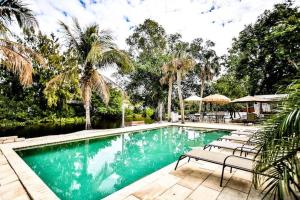 a swimming pool with lounge chairs next to a river at Siesta Key Beach Home in Siesta Key