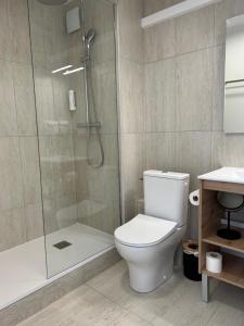a bathroom with a toilet and a shower at Logis Hotel De La Clape in Narbonne-Plage