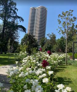 a tall building with a bunch of flowers in a park at tbilisi garden 2 in Tbilisi City