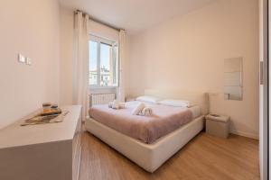 a bedroom with a bed and a desk and a window at PN3 - One bedroom flat in Florence