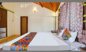 a bedroom with a large white bed in a room at Hotel Mint Resort in Jālna