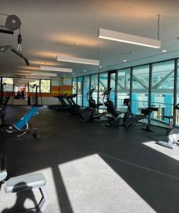 a gym with treadmills and ellipticals in a building at tbilisi garden 2 in Tbilisi City