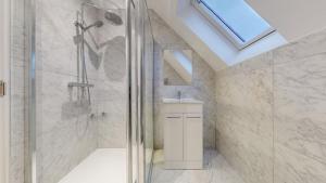 a bathroom with a shower and a sink at LONDON STAY Flats in London