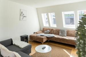 a living room with a couch and a table at Shoreditch Apartments by DC London Rooms in London