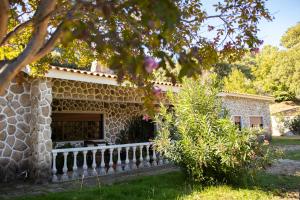 een stenen huis met een hek en een tuin bij Quinta dos Sinçais in Guarda