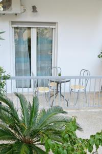 a balcony with a table and chairs on a porch at Dream apartment in Kallithea in Athens