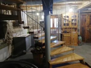 a kitchen with wooden stairs in a room at Apartamentos caravia, el cachucho in Duesos