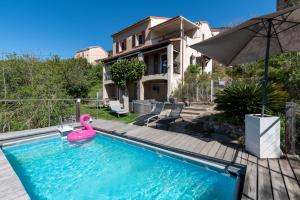 a swimming pool with a pink flamingo in a house at Alta Vista , villa avec piscine privée et vue exceptionnelle près d'Ajaccio in Sarrola-Carcopino