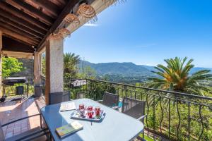 a table on the balcony of a house at Alta Vista , villa avec piscine privée et vue exceptionnelle près d'Ajaccio in Sarrola-Carcopino
