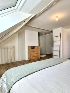 a bedroom with a bed and a ladder and a dresser at Duplex Amour Toujours in Wahlbach