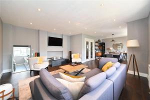 a living room with a large couch and a table at Premier 3 Bed Apartment - Covent Garden in London