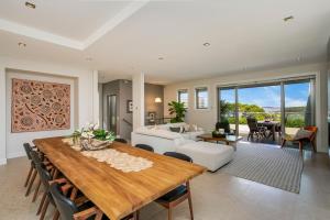 a living room with a dining table and a couch at Manly Harbourside Villa in Sydney